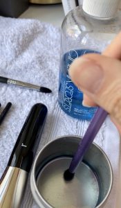 Makeup Brush Cleaning - Spot cleaning technique by dipping a brush in liquid cleanser