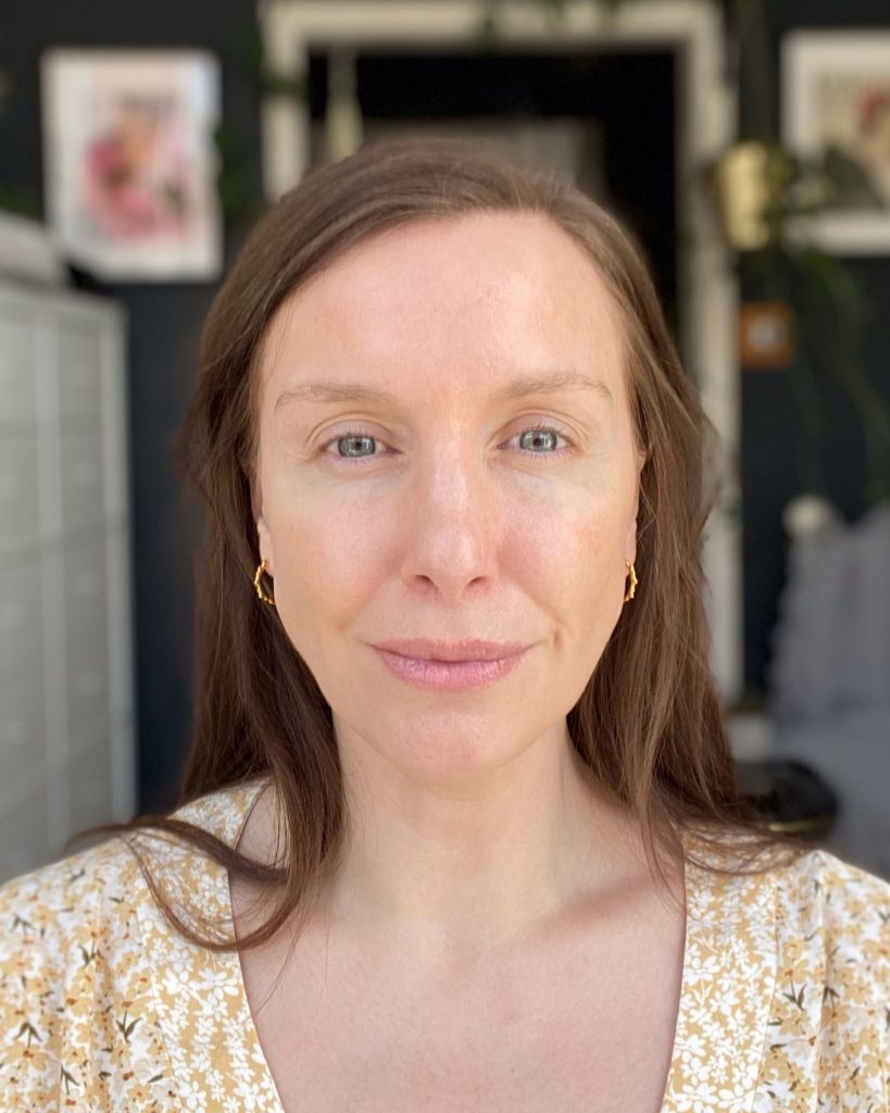 Amy wears Fenty Beauty Bright Fix alone on the viewers left eye and nothing on the viewers right