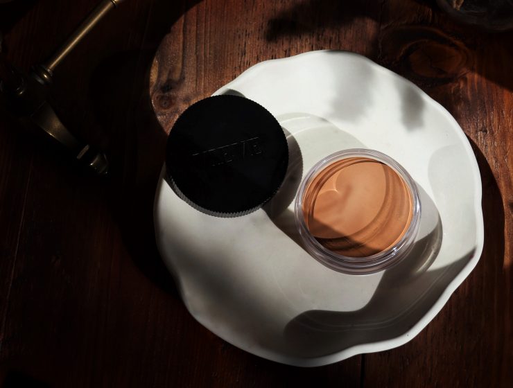 Vieve Radiance Cream Bronzer is photographed from a birdeye, beauty flatlay position. Makeup artist and beauty blogger Amy is reviewing this cruelty free makeup staple in today's post