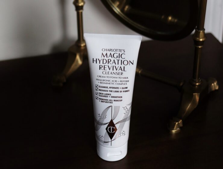 An image of the new Charlotte Tilbury Magic Hydration revival cleanser stands on a makeup vanity
