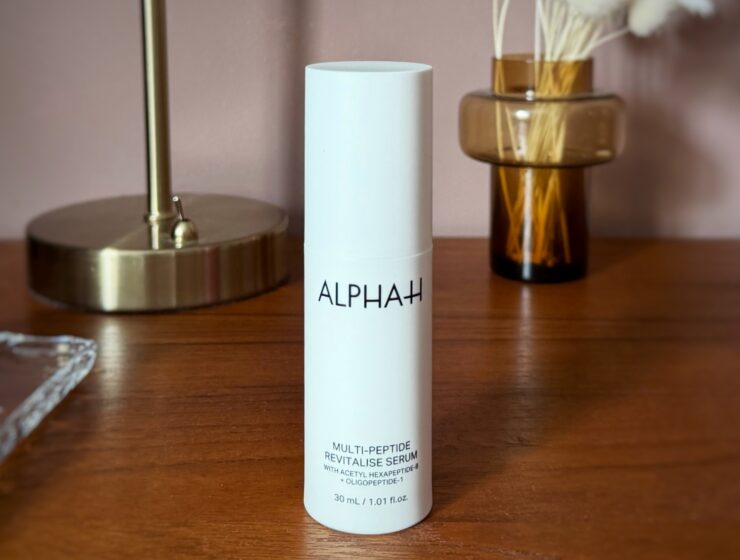 A review using the alphabet h peptide serum over 2 months on 40 yr old skin for anti ageing. This image shows the white bottle on a mid century drawers