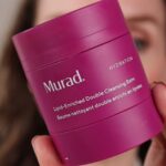 Murad Lipid-Enriched Double Cleansing Balm Review. Amy hold the vibrant pink tub