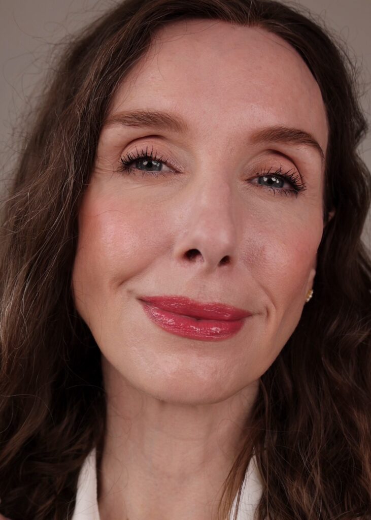 Amy with a full face of makeup in a “before’ cleansing picture