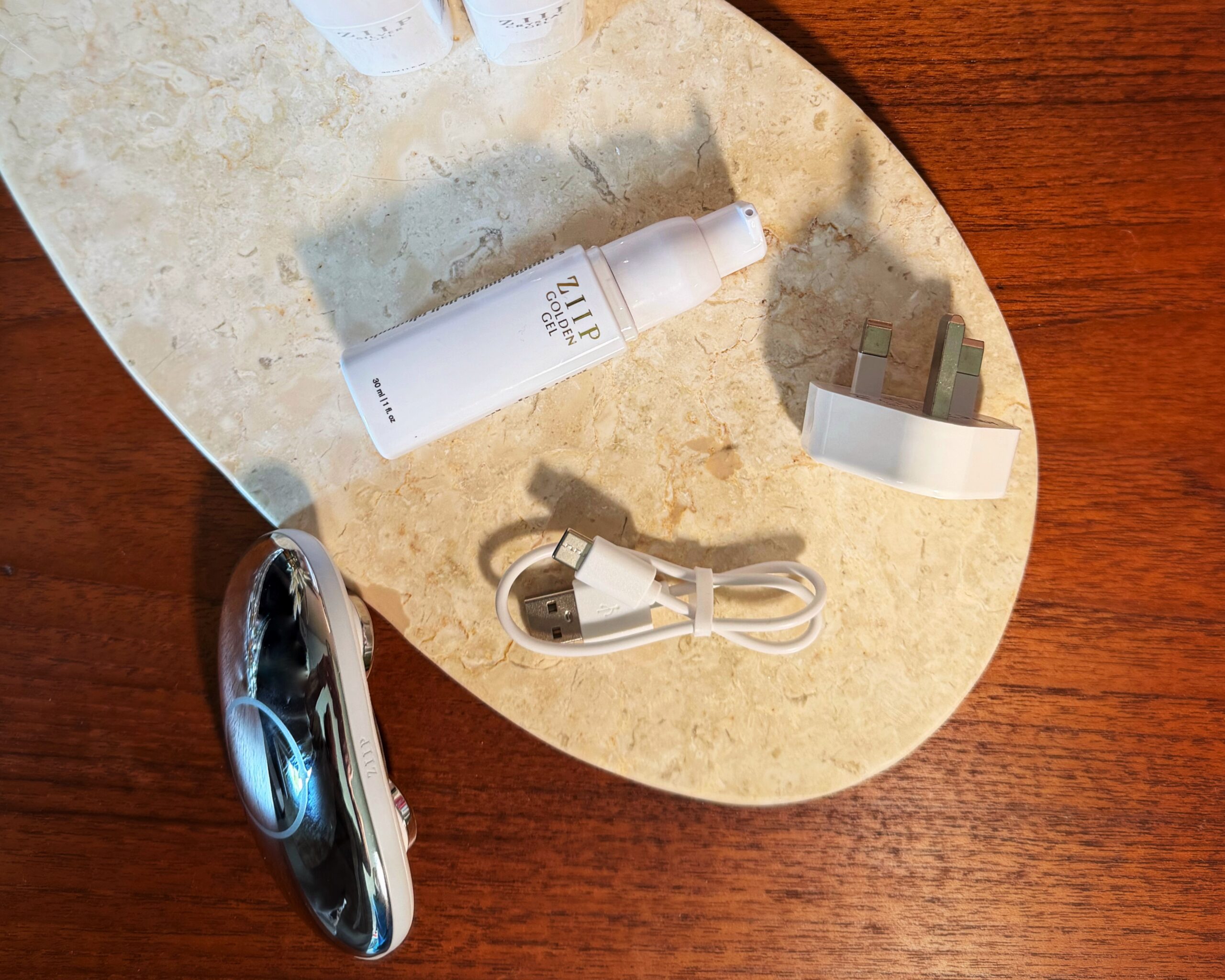 An image of the microcurrent kit and what’s included: gel, power cable, device